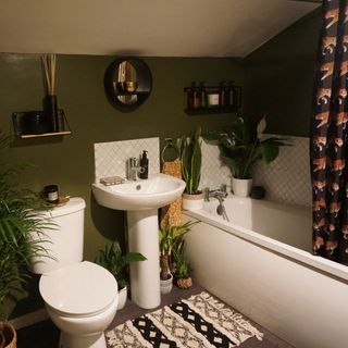 bathroom with white bathtub and white washbasin