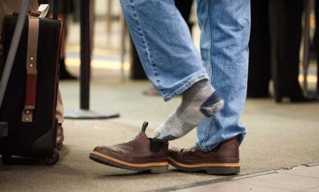 A passenger removes his shoes at the Sacramento international airport: Homeland Security Secretary Janet Napolitano says travelers might soon be able to keep their kicks on during security sc