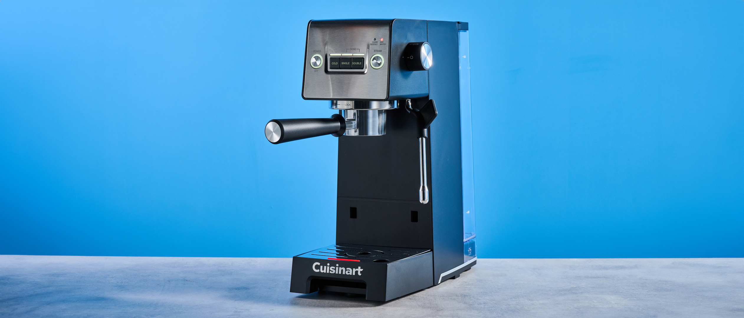 The Cuisinart Espresso Bar Slim espresso machine on a stone surface with a blue background