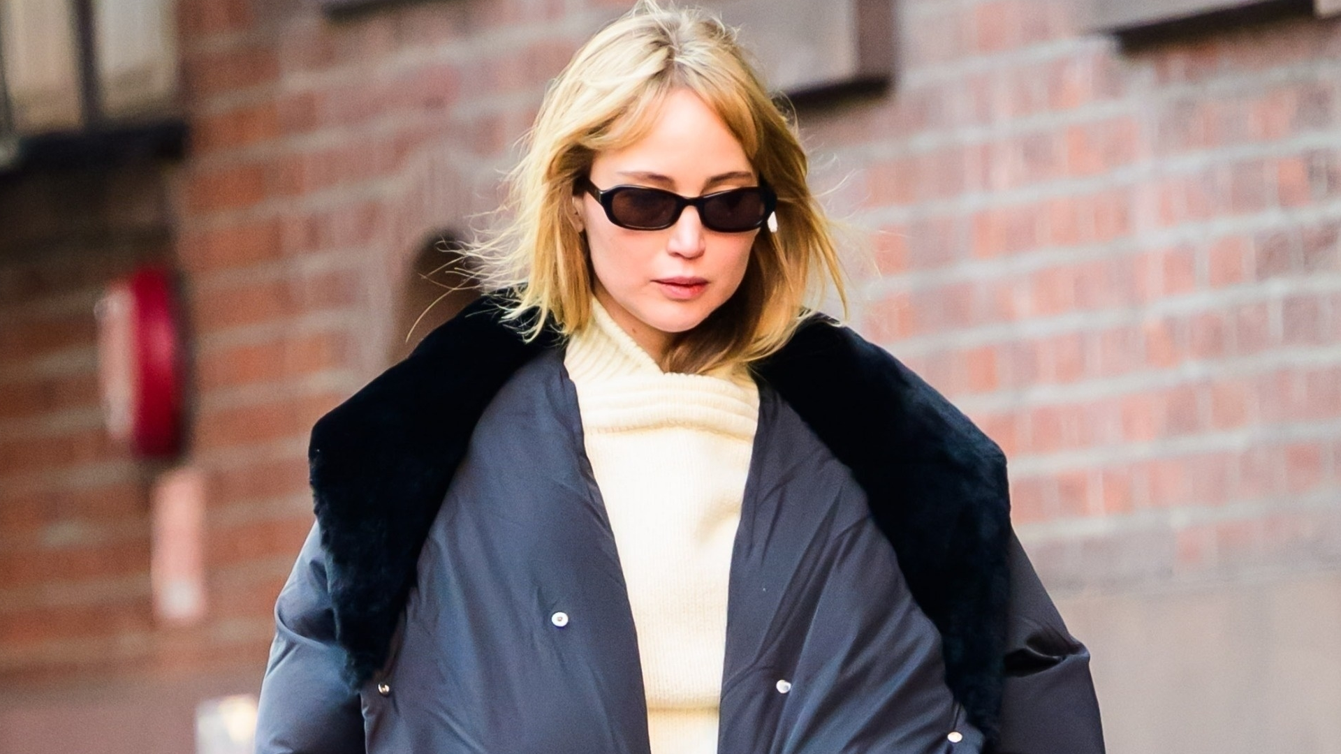 Jennifer Lawrence styled a scarf over pants, a butter yellow rollneck sweater, and socks with ballet flats in NYC