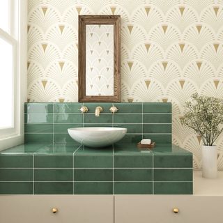 green tiled countertop with freestanding basin and art deco wallpaper