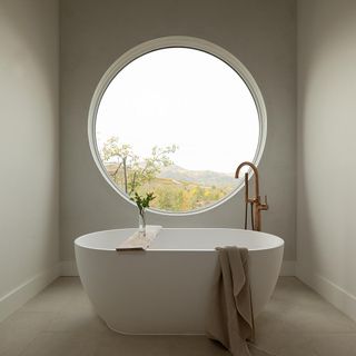 A luxury bathroom with round window