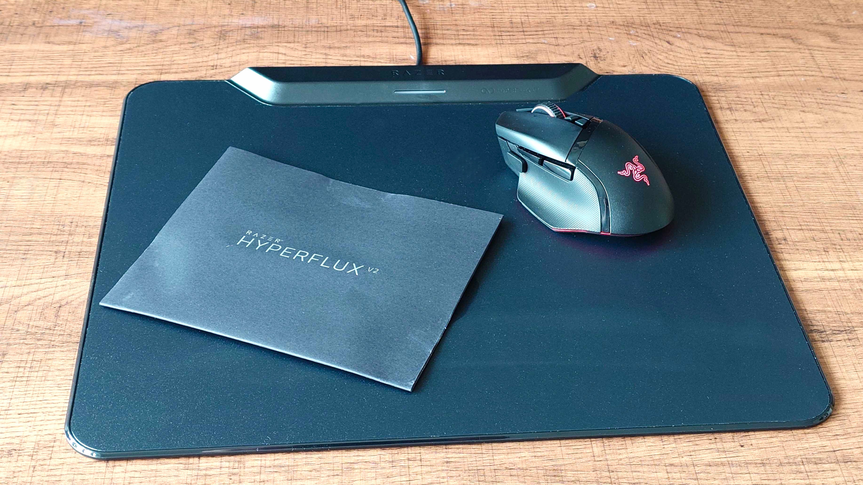 A Razer Basilisk V3 Pro 35K charging on the new Razer HyperFlux V2 mousepad.