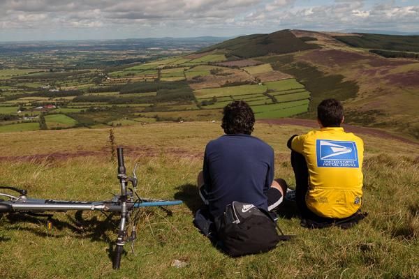 Two cycling fans take in the stunning scenery as they wait for the race to make its way up the narrow road to the top of Mount Leinster.