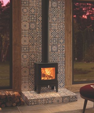 A compact wood burning stove on a geometric tiled mantle