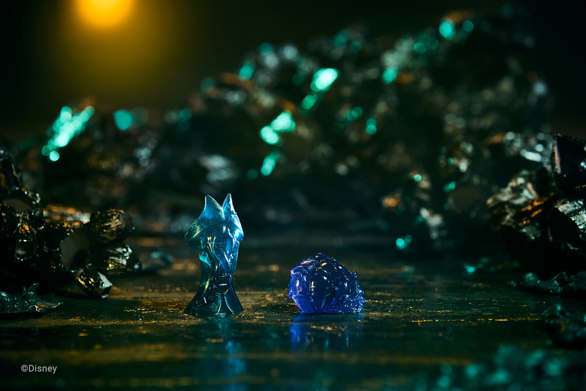 Disney Villainous: Treacherous Tides cards, tokens, and pieces on themed background with barnacles