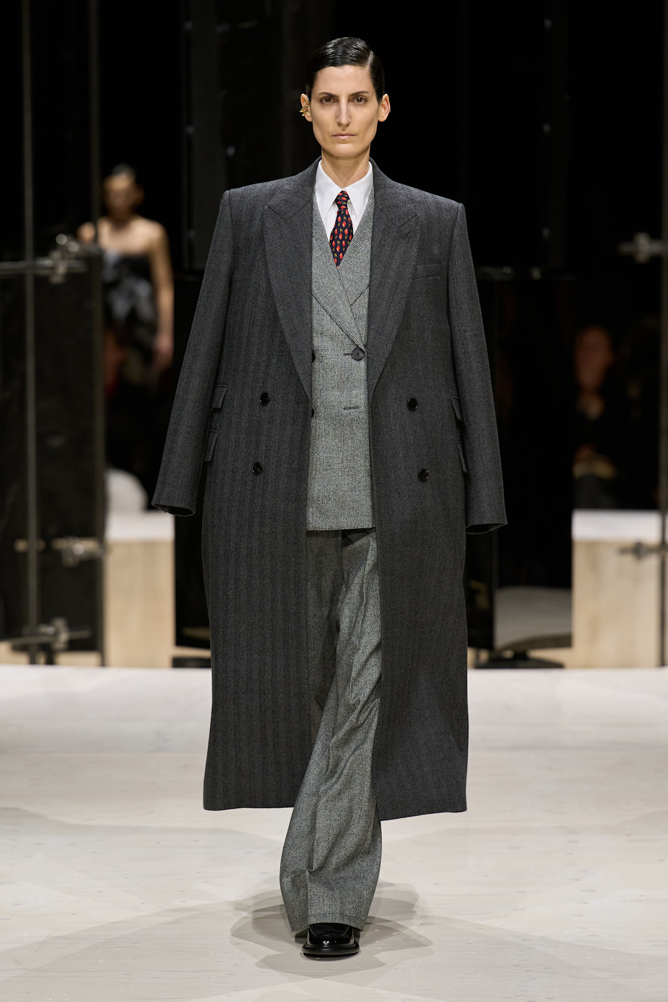 a model wears a tailored look at the givenchy f/w 26 show.