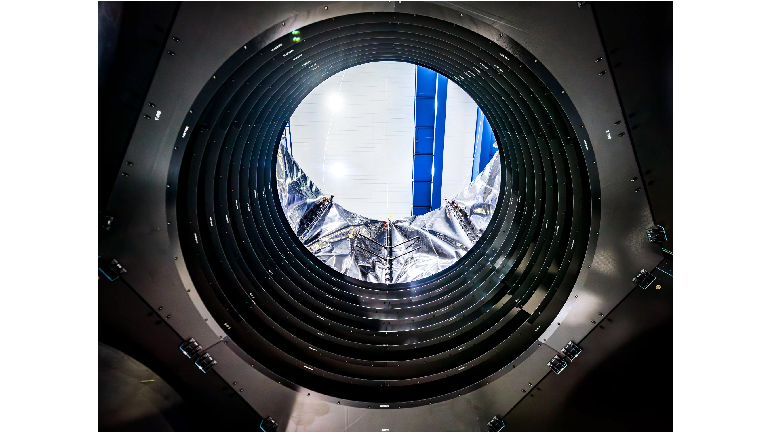 photo looking through an under-construction space telescope's circular aperture inside a clean room