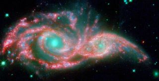 Two merging galaxies look like a mask.