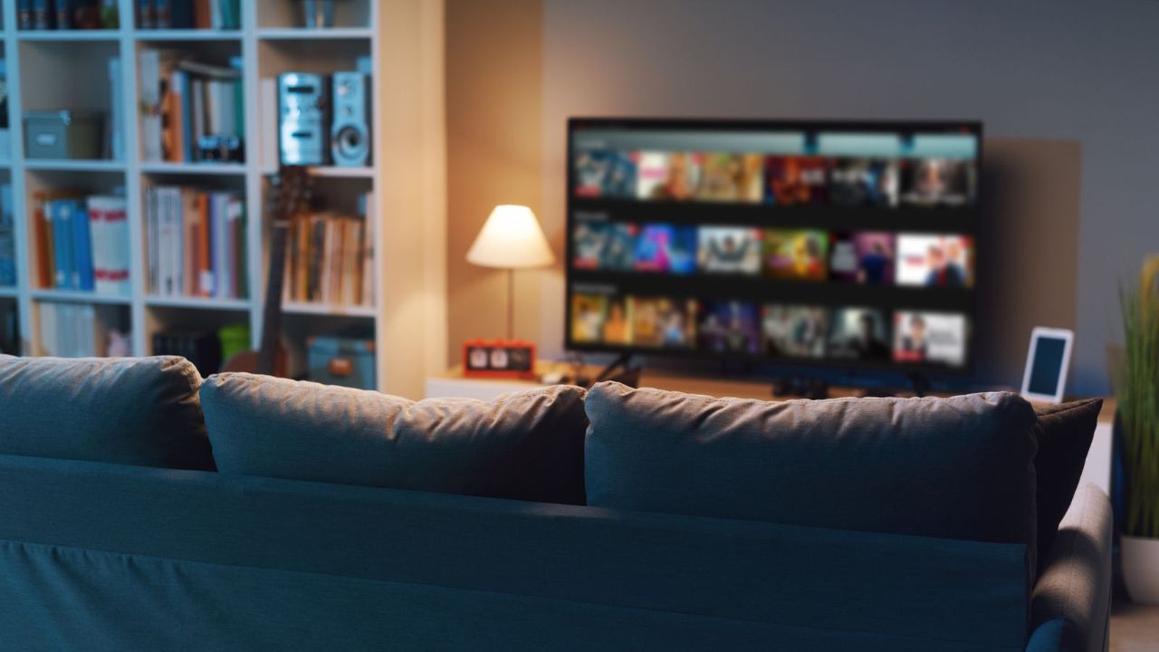 A streaming service menu out of focus in a living room at night 