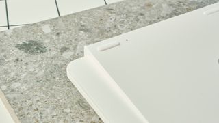 the back of a white keychron keyboard on a white table