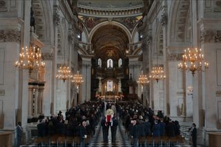 A funeral at St. Paul's Cathedral is filled with mourners as pall bearers carry the casket, in 'The Diplomat.'