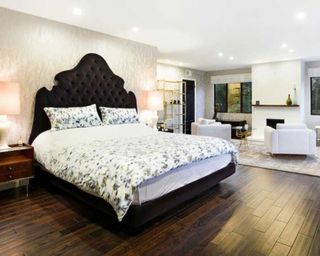 bedroom with wooden flooring and king size bed