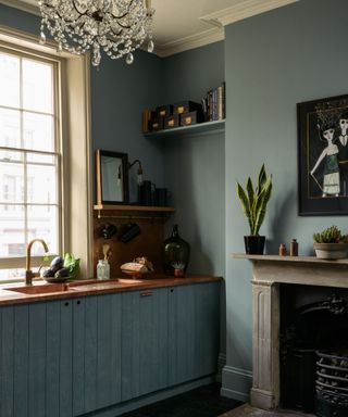small kitchen with narrow shelves added in an alcove