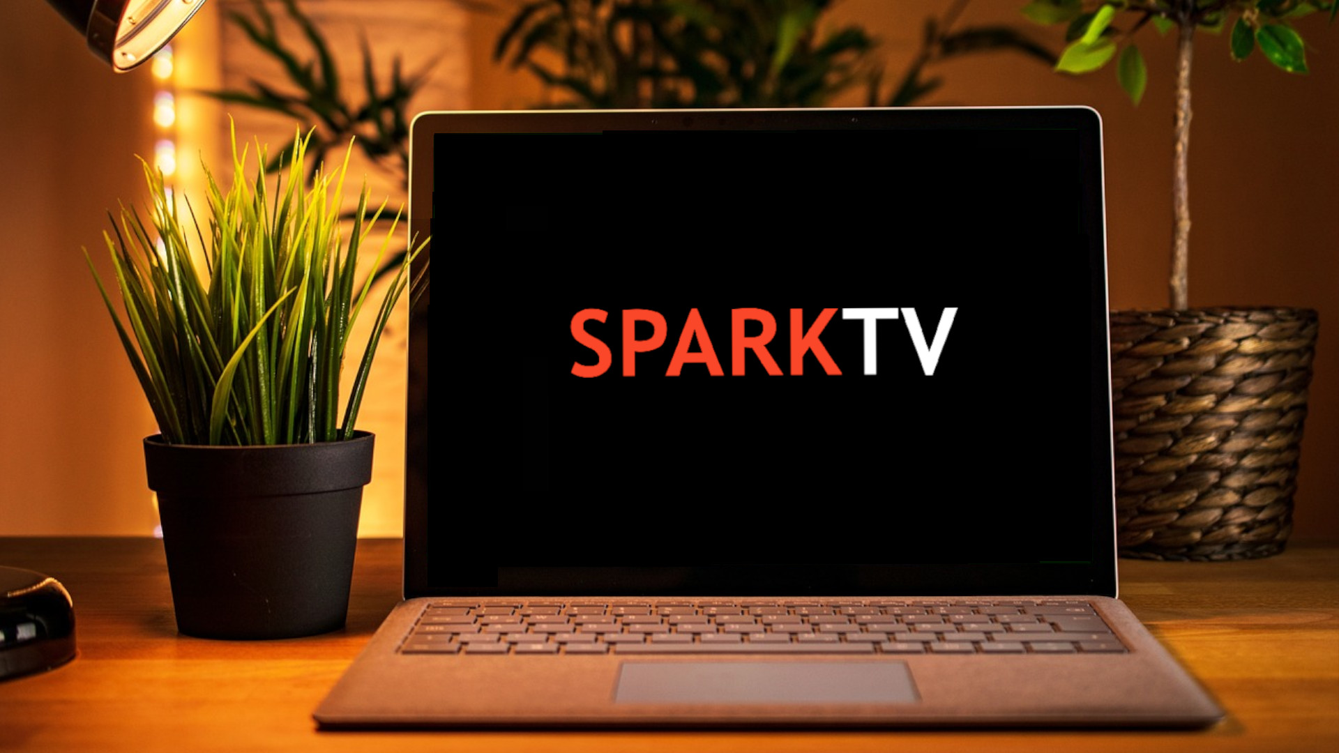 A laptop with the logo for SparkTV on the screen