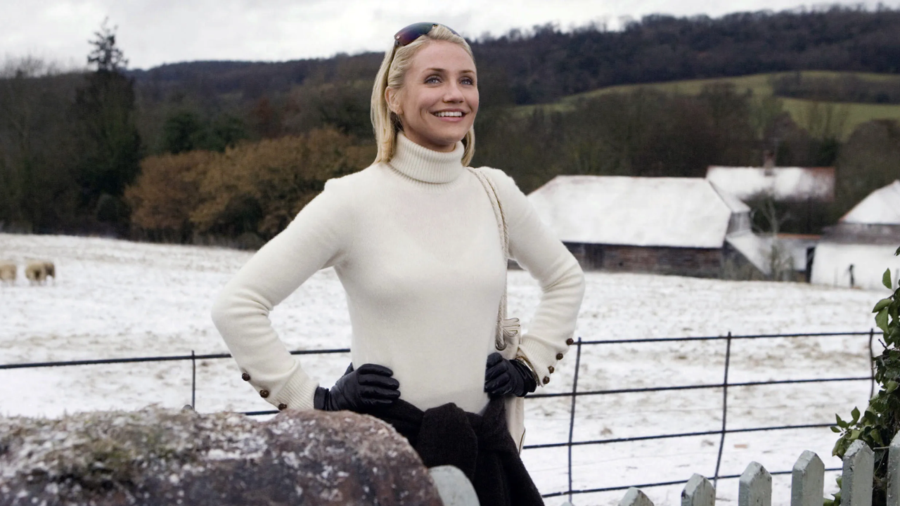 cameron diaz in a white sweater outside of an english cottage in the holiday