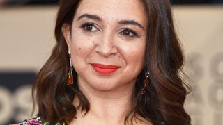 Maya Rudolph wearing sparking silver makeup with red lipstick