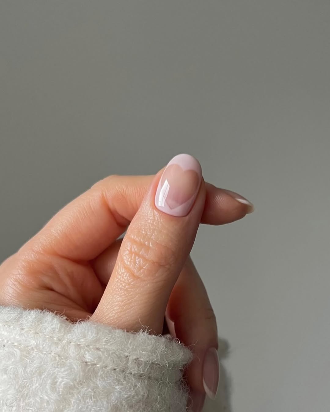 A pastel pink negative space manicure by Georgia Rae