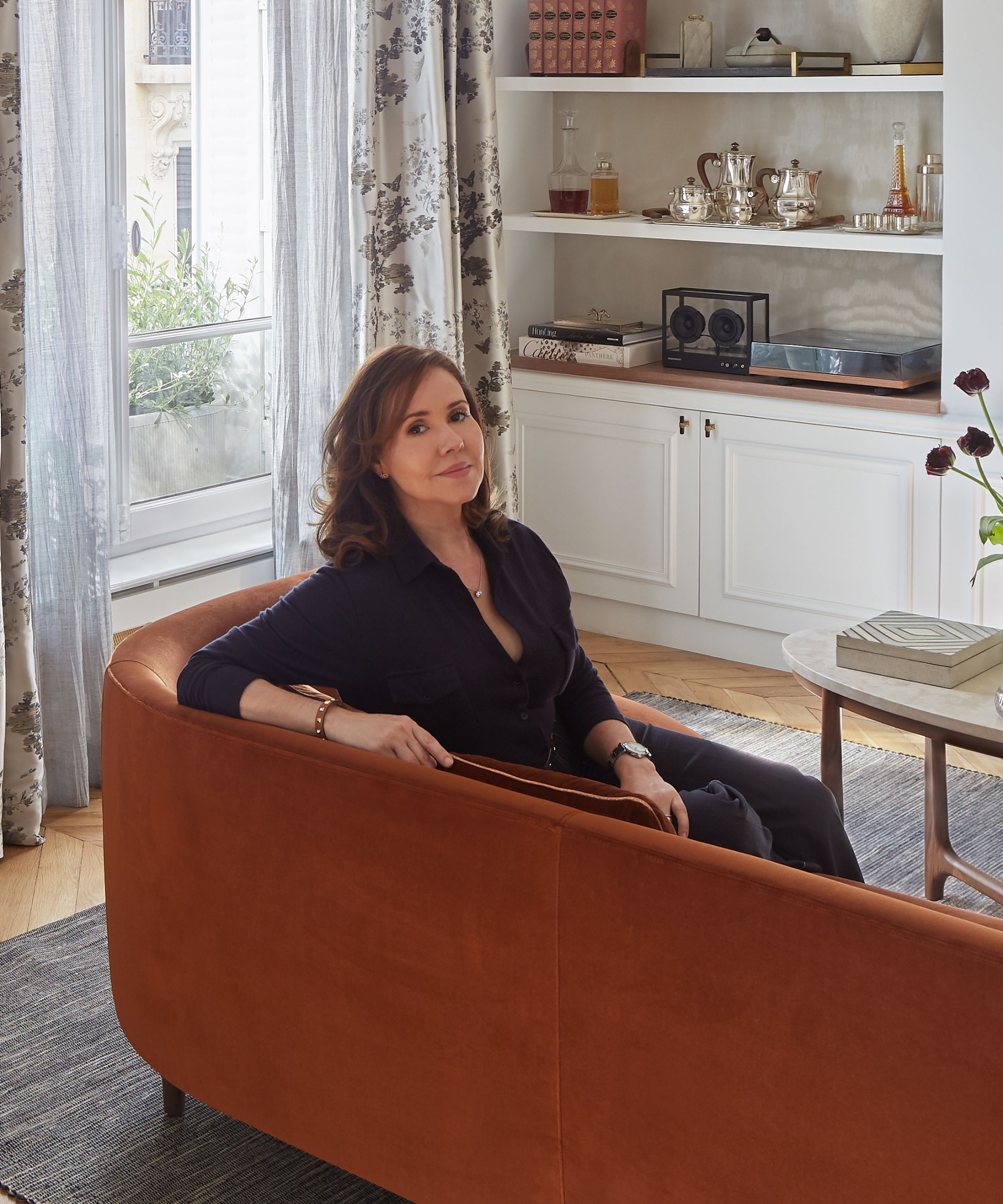 designer Lichelle Silvestry sitting on russet sofa