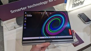 The Lenovo ThinkBook Plus Twist laptop on a display stand at the MWC 2023 event.