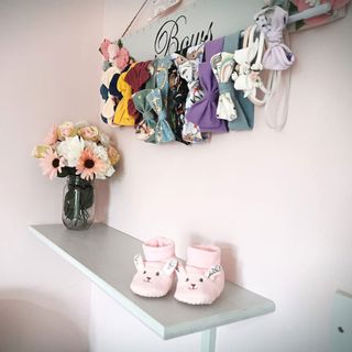 room with pink walls and homemade bow holder