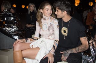 Gigi Hadid and Zayn Malik sitting at a Givenchy fashion show in October 2016