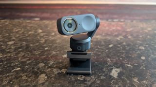 The Insta360 Link 2 Pro webcam, pictured on a marble worktop.