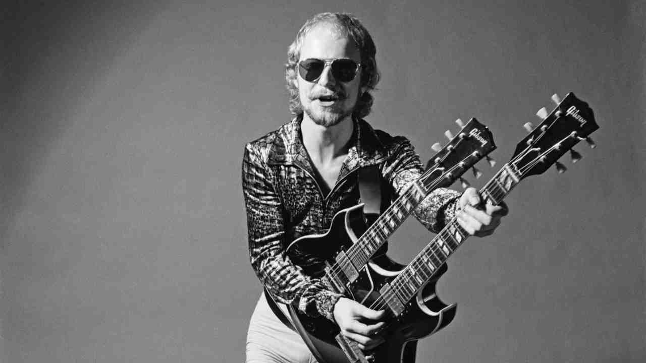 Wishbone Ash&amp;rsquo;s Andy Powell posing for a photograph with a double-necked guitar in the 1970s