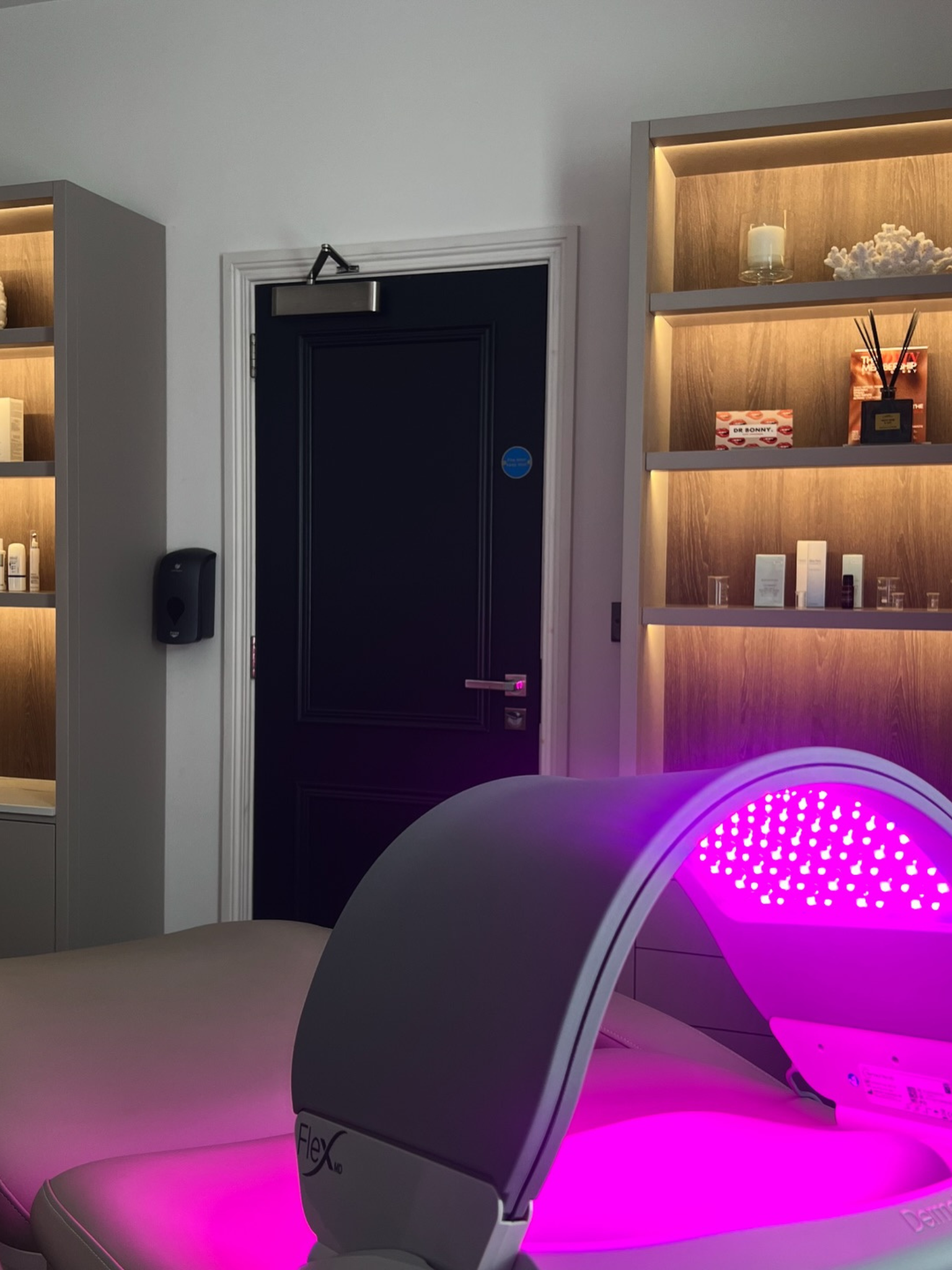 The interiors at Dr Bonny, an LED panel on a treatment bed
