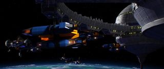 Making the Trailmakers 2.0 cinematic; A digital illustration depicts several spaceships orbiting a large, stationary space station in a dark space environment