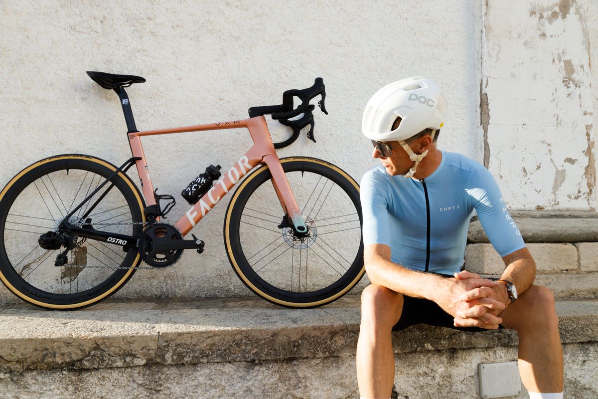 David Millar sits next to a Factor Ostro Vam, which leans against a wall