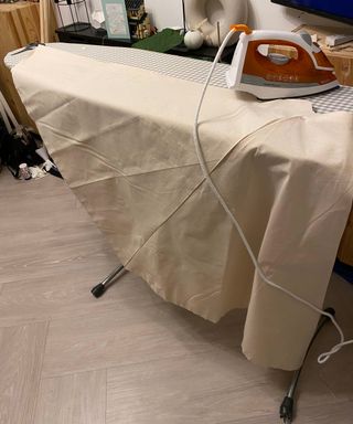 fabric and iron on an ironing board in a living room