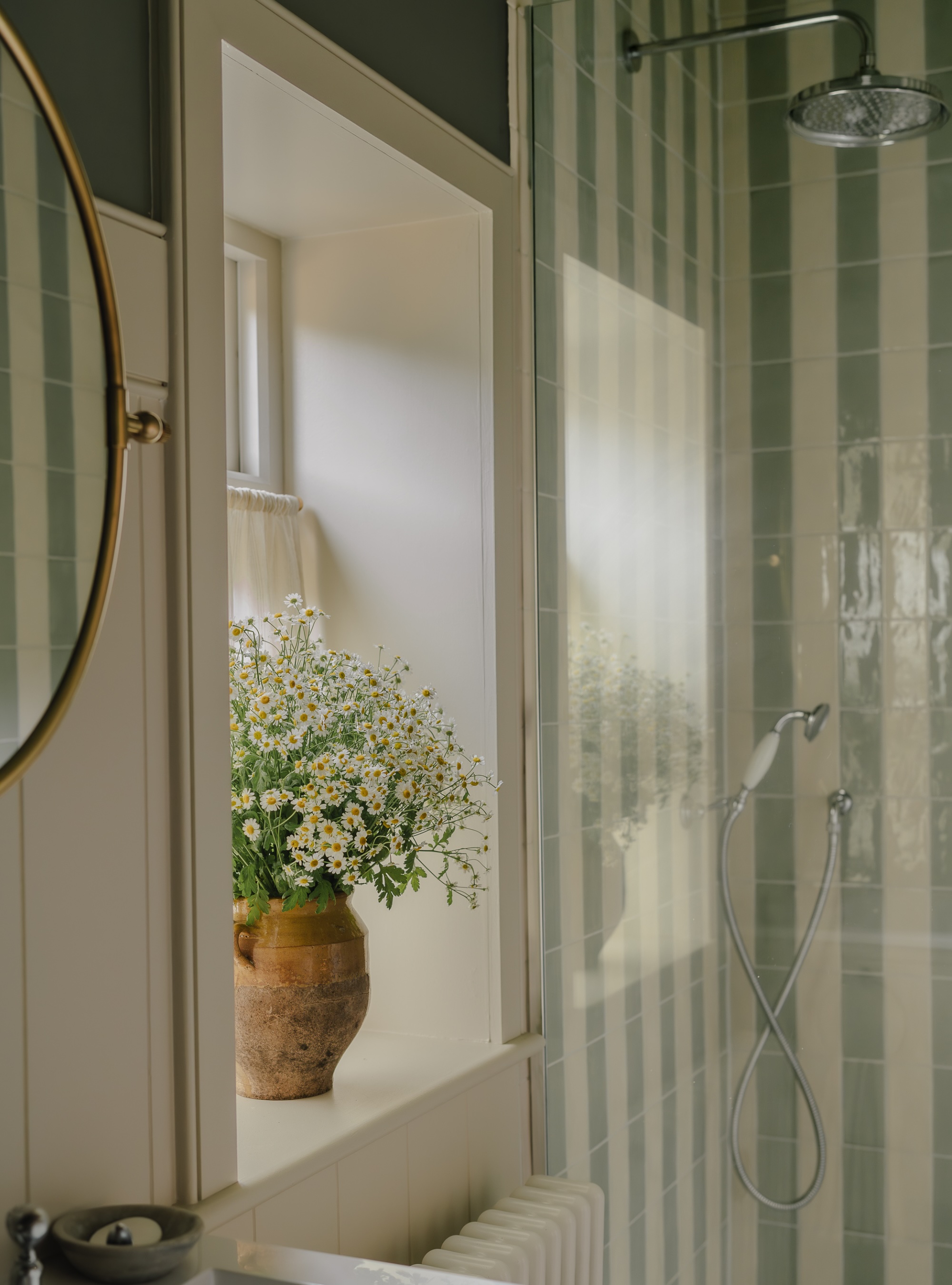 Sage striped tiles in shower with a bunch of flowers