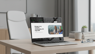 Sage CRM being used on a macbook pro in a modern office