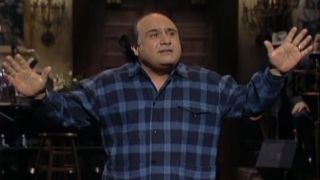 Danny DeVito with his arms spread on SNL