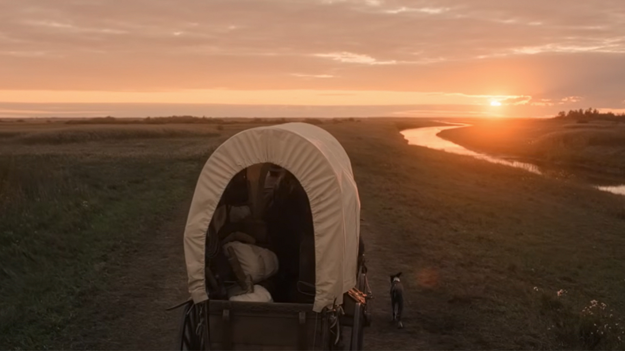 A covered wagon traveling into the sunset in Little House on the Prairie
