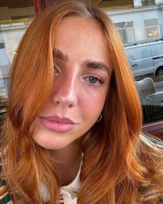 Image of woman with red hair and glowing skin