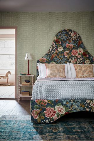 An example of headboard ideas showing a dark green and floral bed