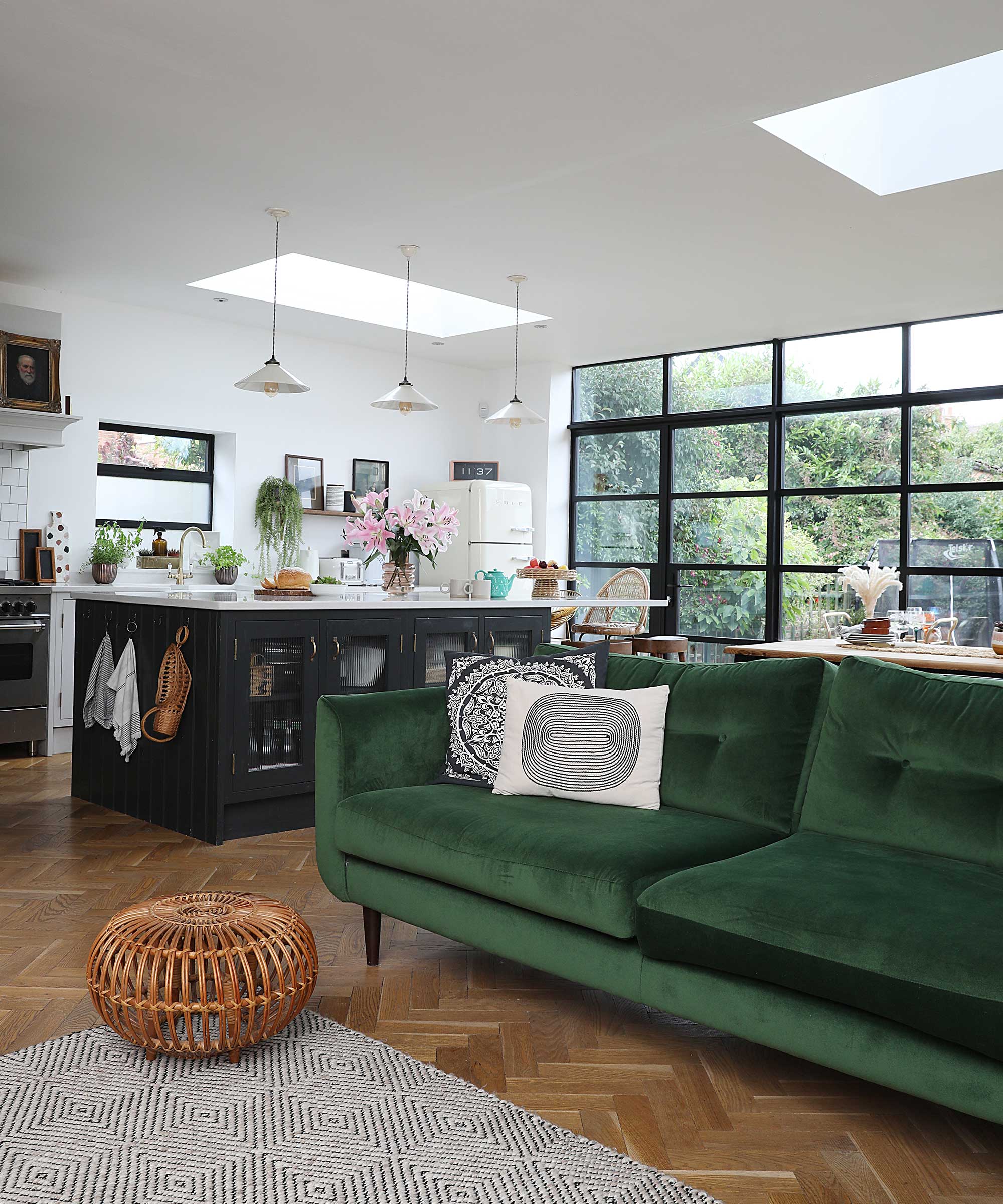 kitchen extension with wooden flooring and green velvet sofa