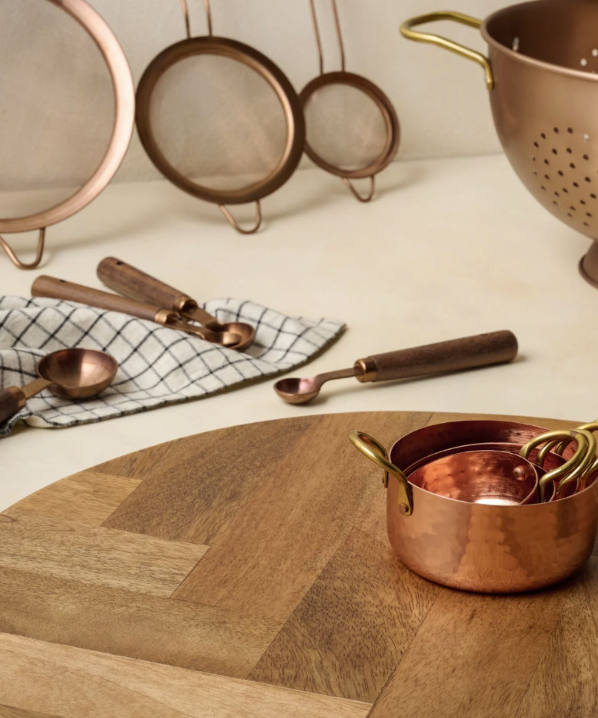 Copper bakeware on a round wood board