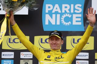 Team Visma-Lease a Bike's US rider Matteo Jorgenson wearing the overall leader's yellow jersey celebrates on the podium after winning the 3rd stage of the Paris-Nice cycling race, a 28,4 km team time trial between Nevers Magny-Cours Circuit and Nevers, on March 11, 2025. (Photo by Anne-Christine POUJOULAT / AFP)