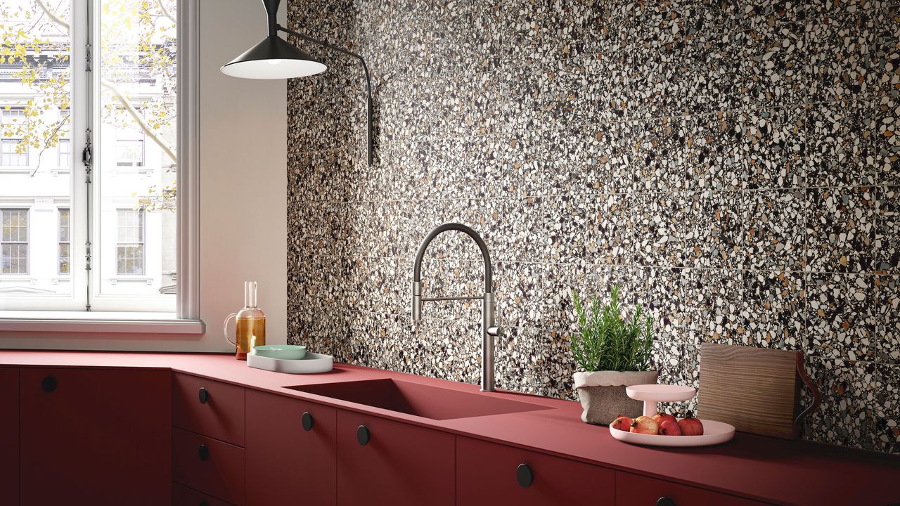 kitchen with magneta cabinets and black wall lamp