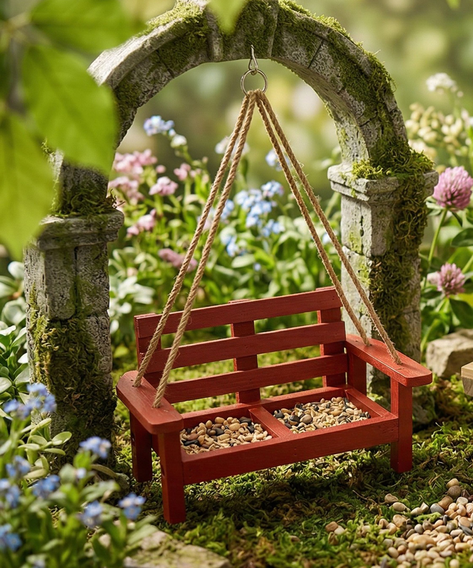 ALDI's Belavi red bench bird feeder under gothic-style archway