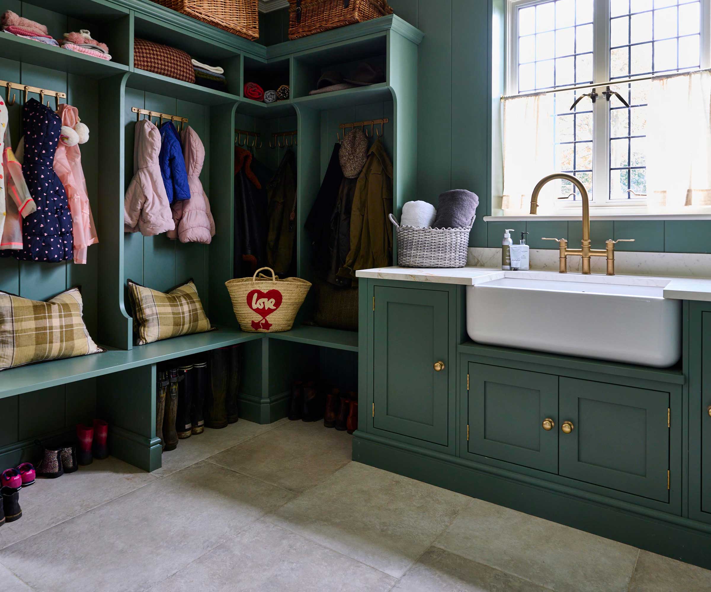 green utility room boot room with Belfast sink and stone flooring