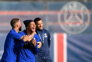 Paris Saint-Germain's Spanish defender Sergio Ramos (L) jokes with Paris Saint-Germain's French forward Kylian Mbappe during a training session at the club's Camp des Loges training ground in Saint-Germain-en-Laye, near Paris on October 10, 2022, on the eve of their UEFA Champions League first round Group H football match against Benfica.