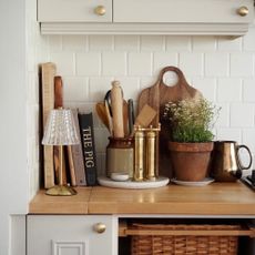 Kitchen counter with a wireless lamp, books and kitchen utensils