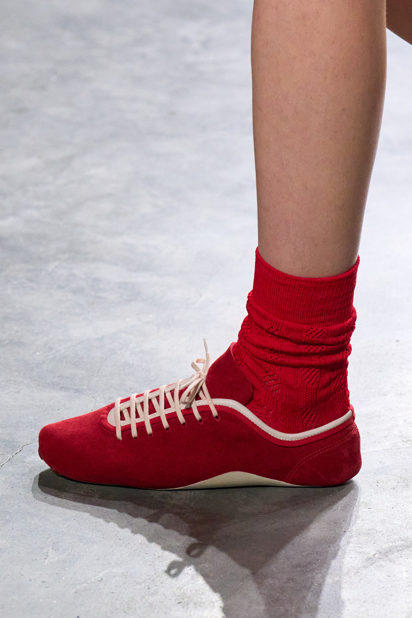woman in red sneakers and socks