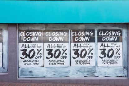 Closing down sale posters in a shop window