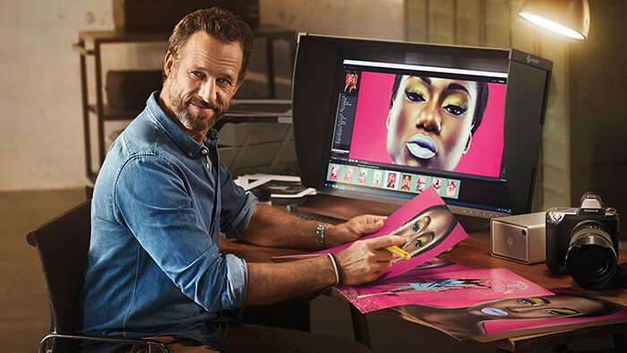 Man using the Eizo ColorEdge CG319X, one of the best monitors for MacBook Pro