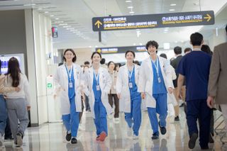 A group of medical residents walk through a hospital corridor, in 'Resident Playbook.'